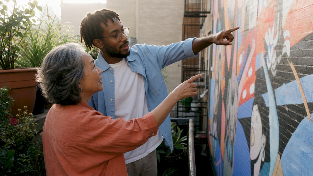 Diverse group discussing community mural outdoors