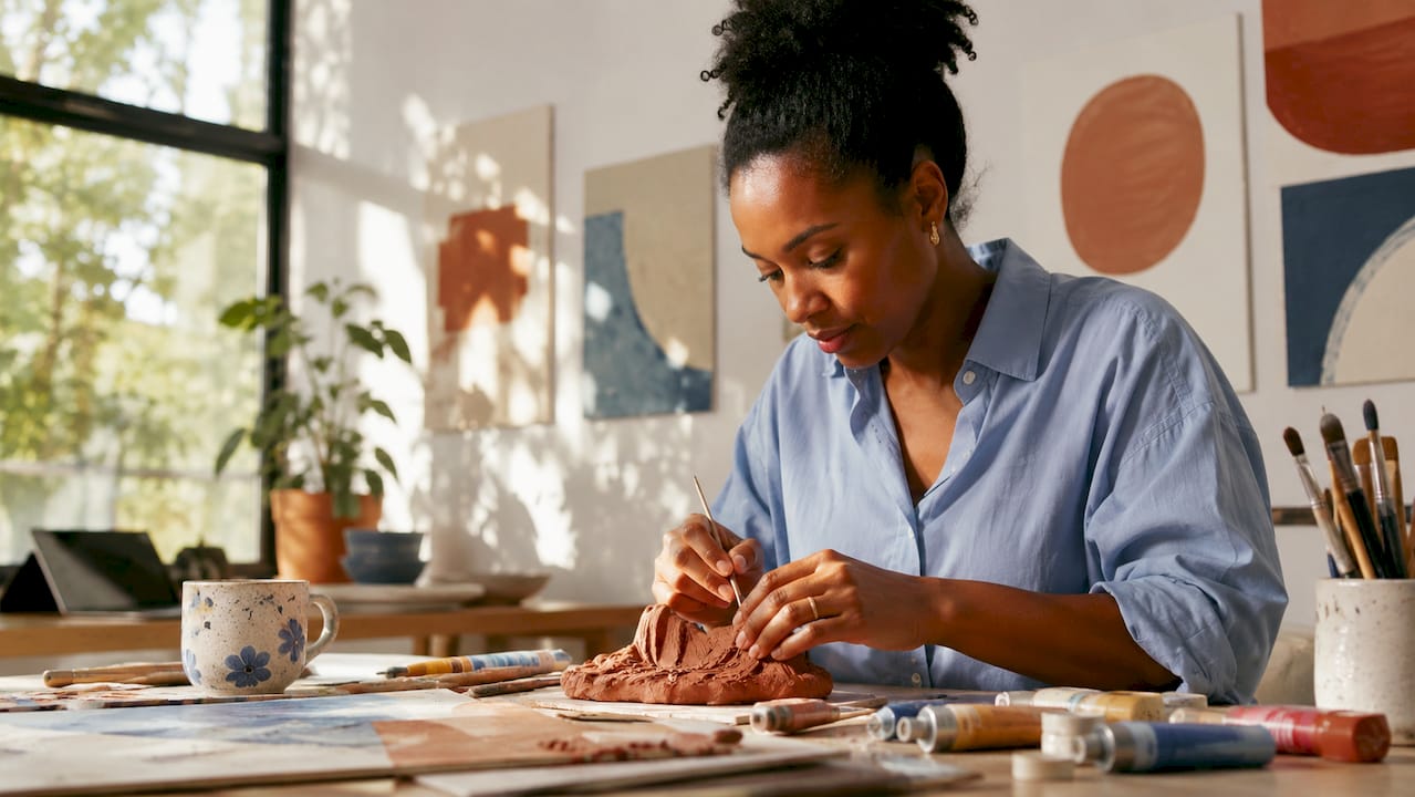 Artist sculpting tactile inclusive artwork