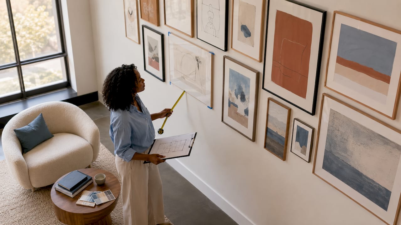 Interior designer planning gallery wall in large loft
