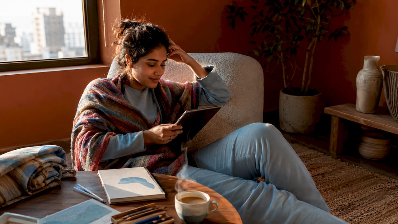 Woman browsing online art marketplaces on tablet